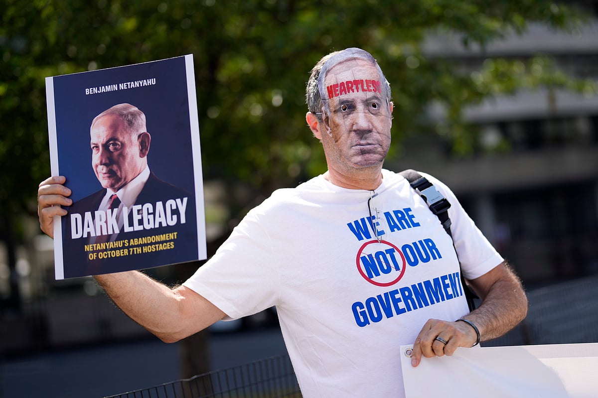 A protester demonstrates near The Watergate Hotel, Tuesday, July 23, 2024, in Washington - AP